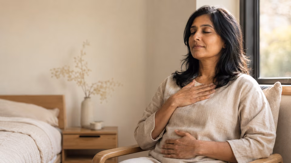 Woman practicing breathing meditation for anxiety with one hand on her chest and one on her belly