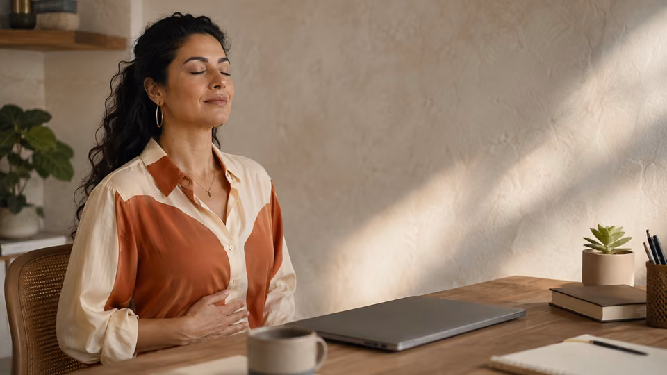 Woman taking a five-minute breathing meditation pause during a busy workday