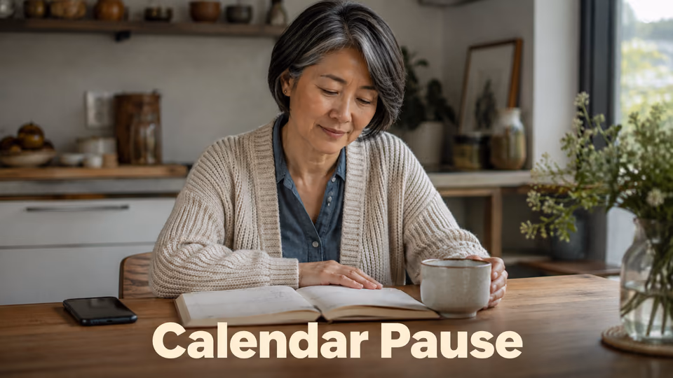 Woman pausing beside an open planner during a busy morning