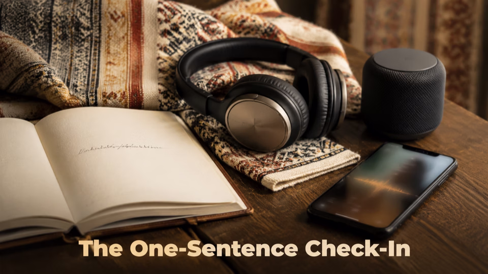 Open journal beside headphones, a phone playing audio and a small speaker